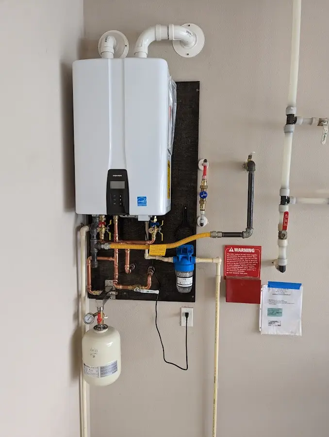 Professional plumber installing copper piping in a West Bloomfield home